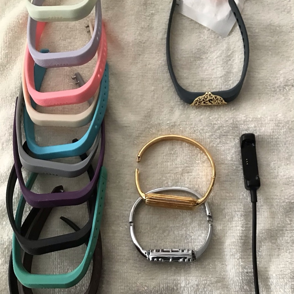 Fitbit Flex 2 with charger and multiple bands.